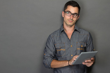 young man with tablet looking up to copy space