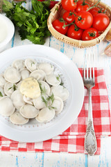 Meat dumplings with sauce on plate on table close-up