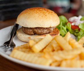 burger with French fries on the table in a cafe