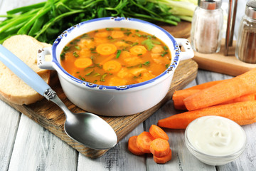 Composition with carrot soup, ingredients and herbs