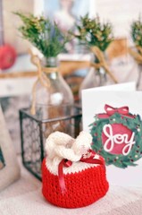 Small Christmas gift wrapped in a red and white knitted sack