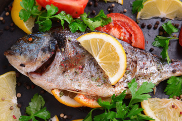 Tasty baked fish in foil on table close-up