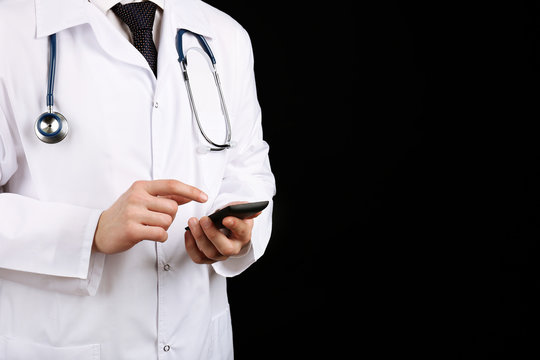 Doctor Working With Mobile Phone On Black Background