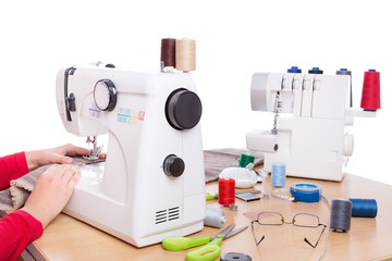 Woman seamstress work on the sewing products.