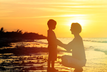 Fototapeta premium father and son holding hands at sunset