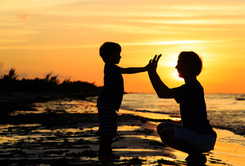 father and son playing at sunset