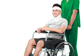 nurse pushing young patient in wheelchair