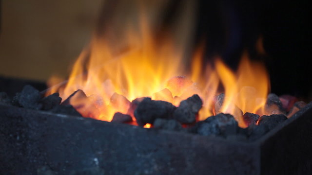 Bright flame of fire burns in a forge horn