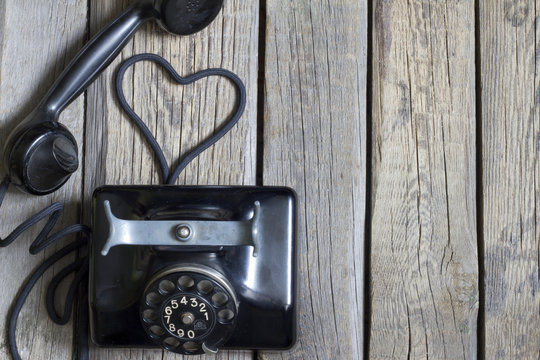 Old retro telephone with heart shape abstract concept