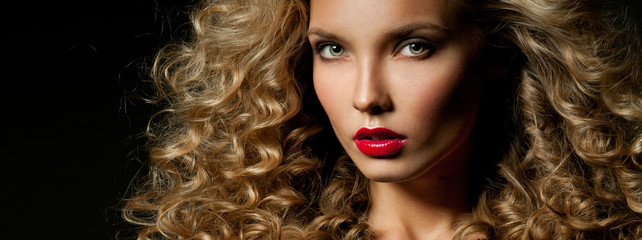 Beautiful woman with magnificent curly hair. Red lipstick.