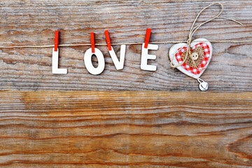 love word and heart on wooden background