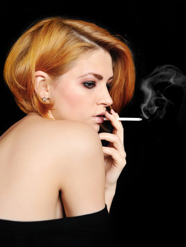 Portrait of beautiful redheaded girl that smokes
