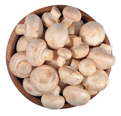 Mushrooms in a wooden bowl on a white