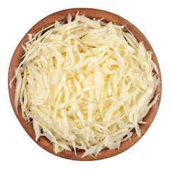 Chopped white cabbage in a wooden bowl on a white