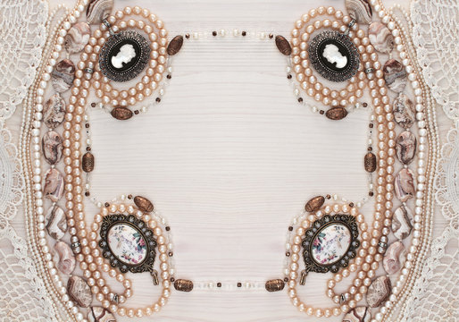 horizontal symmetrical frame of female ornaments on a light wood