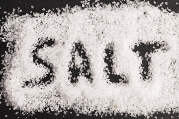 The word salt written into a pile of white granulated salt