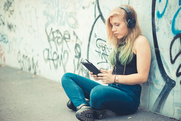 Fototapeta na wymiar beautiful young blonde hair woman hipster listening music