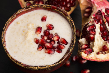 Dish of banana millet breakfast pudding with pomegranate