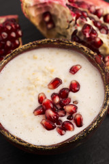 Dish of banana millet breakfast pudding with pomegranate