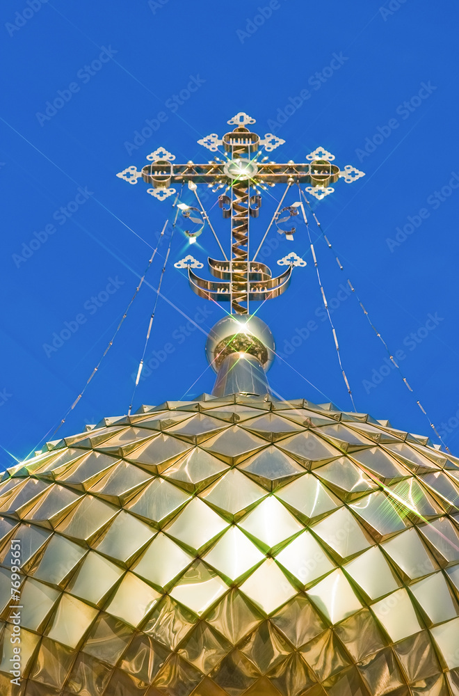 Sticker Golden orthodox cross against blue sky background