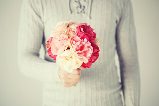 man holding bouquet of flowers