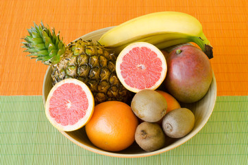 Delicious tropical fruit in the wooden bowl