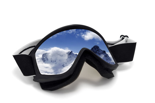 Ski goggles with reflection of winter mountains