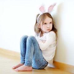 Angry little girl wearing bunny ears © MNStudio