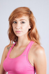Fototapeta premium Redhead woman in exercise outfit, looking focused