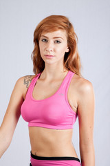 Fototapeta na wymiar Redhead woman in exercise outfit, looking focused