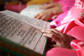close up muslim child and book in school