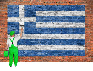 House painter paints flag of Greece on brick wall