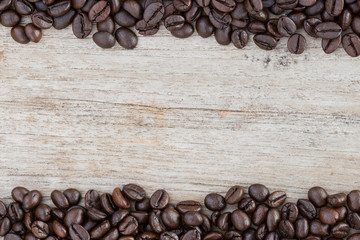close up coffee beans on wood background space for sample text