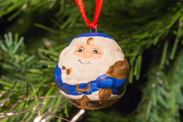 blue santa claus shaped ball decoration on christmas tree