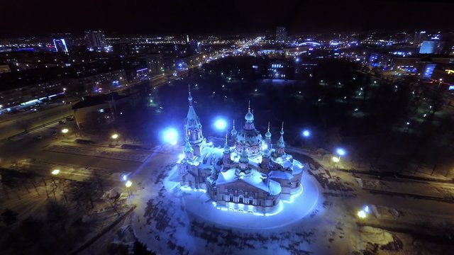 Orthodox church in the city center at night. Aerial