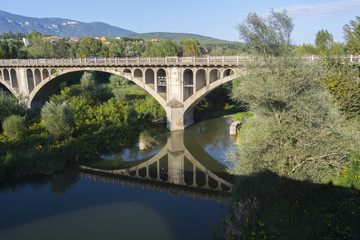 Fototapeta na wymiar Reflection of bridge over rive