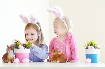 Two sisters wearing bunny ears on Easter