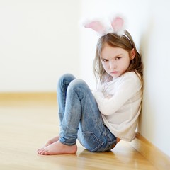 Angry little girl wearing bunny ears © MNStudio
