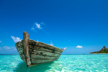 Perfect tropical island paradise beach and old boat