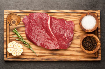 Raw beef steak, pepper and rosemary