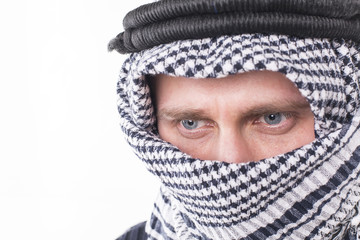 man's face covered with Arab scarf