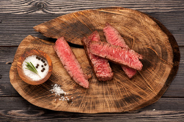 Beef steak slices on a wooden board