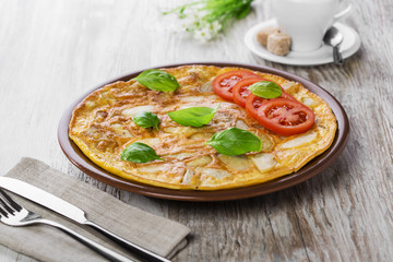 potato omelette with tomatoes on a plate