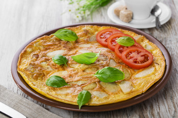 potato omelette with tomatoes on a plate