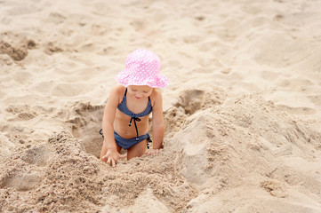 child in the sand on the beach