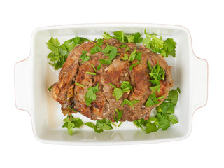 A large piece of veal pork cooked in the oven with a ceramic bak