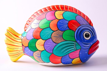 multicolored ceramic fish on white background