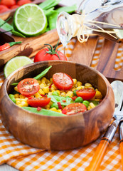 Fresh salad with corn, peas, tomato and chilli