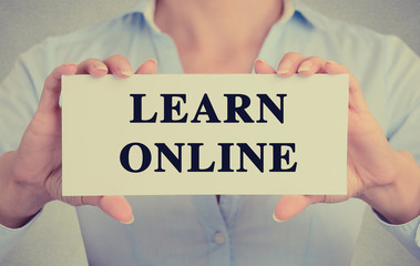 businesswoman hands holding sign learn online message