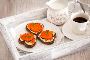 Romantic breakfast-toasts  with red caviar and coffee